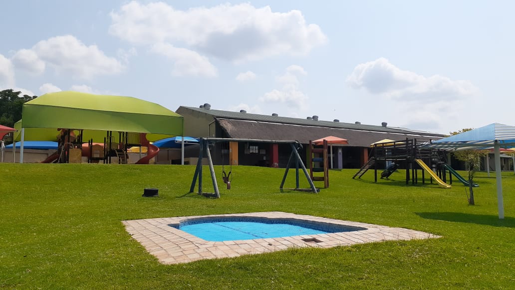 Aerial view of the Gnu Kids outdoor lawns, playgrounds and splash pool